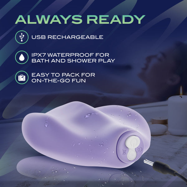 The Pulse Pad Squishy Silicone External Vibrator with Remote is shown wet, emphasizing its USB rechargeability, IPX7 waterproofing for bath or shower use, and compact design for travel. A relaxing bath scene appears blurred in the background.