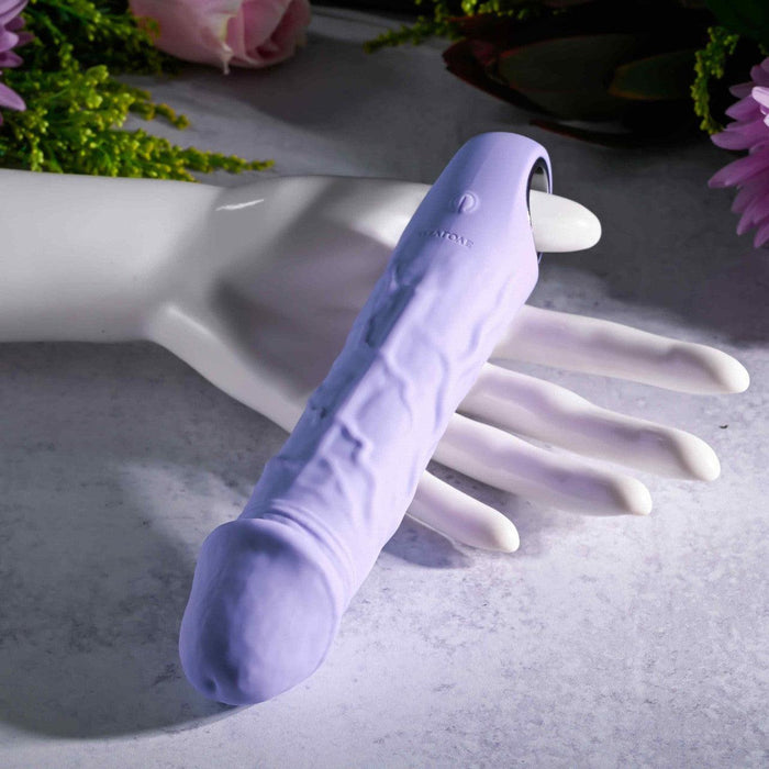 Lavender silicone vibrating dildo with realistic veining, a pronounced tip, and a convenient base finger loop.