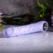 Lavender silicone vibrating dildo with realistic veiny texture, pronounced tip, and a metallic finger loop base.