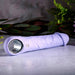 Lavender silicone vibrating dildo with realistic veiny texture, silver finger loop, and metallic control button.
