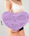 Liberator Faux Fur Heart Wedge Sex Positioning Cushion - Purple held by model in white and black lingerie 