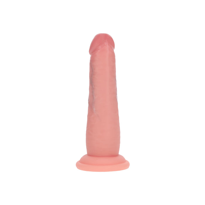 The Realrock Sliding Skin Dual Density Silicone Dildo 6 Inches – Vanilla features a lifelike, flesh-toned look with a rounded tip, veined texture, and flared base, standing upright against a white background.