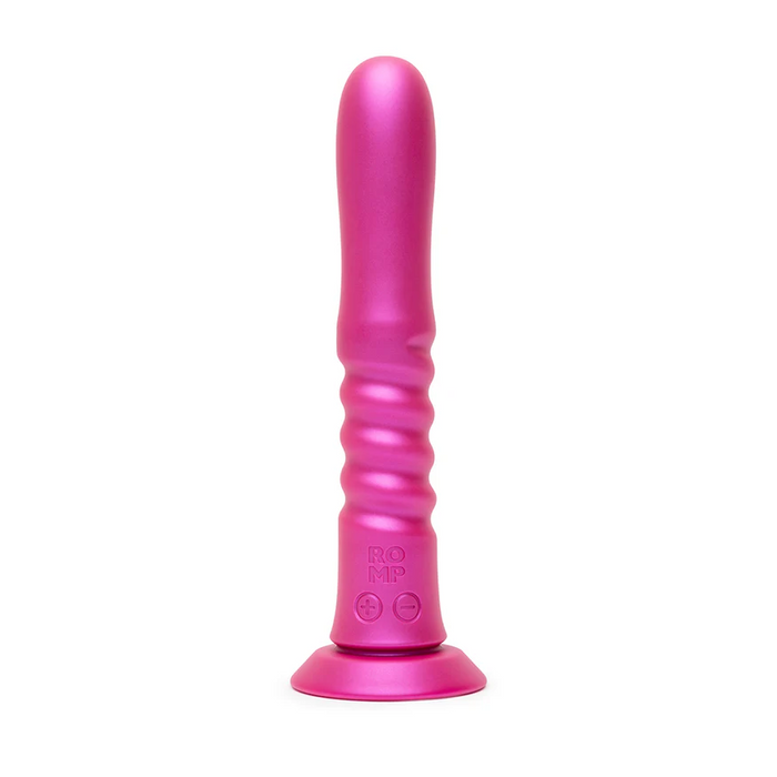 The ROMP Jiggle Thrusting Vibrator features a pink silicone body with a smooth tip, curved ridges on the shaft, and a wide suction base for hands-free pleasure.