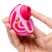 A hand holds the Romp Spin Small Discreet Pleasure Air Clitoral Stimulator, a pink and red travel-sized vibrator with a circular opening and control buttons, while another hand points toward the opening.