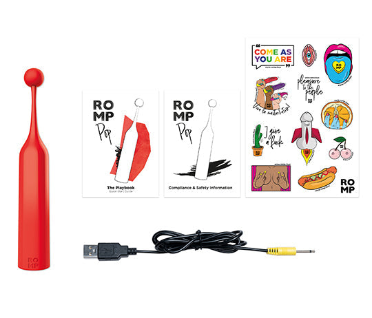 The Romp Pop Pinpoint Clitoral Stimulator with 2 Heads, a red waterproof vibrator, USB charging cable, two instruction booklets, and a sheet of colorful stickers are arranged on a white background.