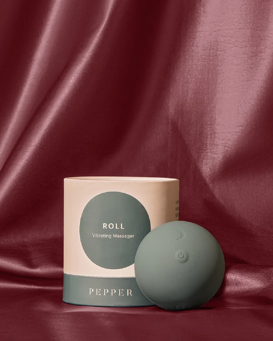 Sentence with replacements: Pepper Roll Vibrating Massager showcase, elegantly presented against a draped satin background.