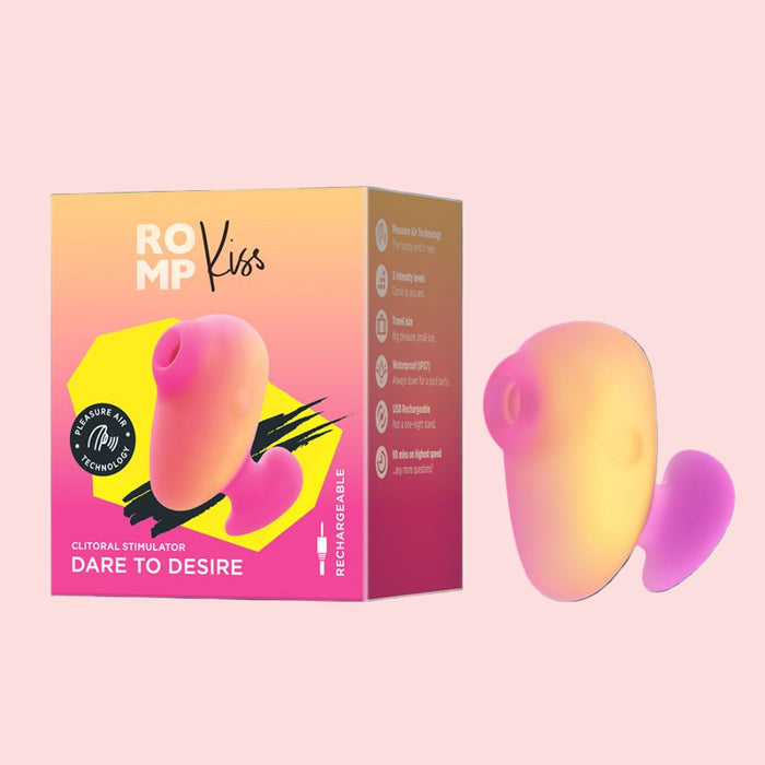 The ROMP Kiss Beginner Air Pulsation Clitoral Stimulator is shown with an ergonomic design and vibrant pink, yellow, and orange gradient. The travel-size device matches the packaging colors and is highlighted next to the box, featuring its air pulsation capability.