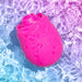 The Romp Rose 2 Pleasure Air Clitoris Stimulator—a bright pink, rose-shaped silicone toy—floats with water droplets on a blue and purple gradient background, hinting at innovative clitoral stimulation.