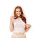 A smiling woman with long red hair wears a white bridal veil, sheer white crop top, and matching underwear. She points to her top while holding pink beads and wearing the Peaches 'n Cream Collar and Nipple Clamps. The background is white.