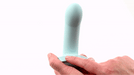 A hand holding a blue Myst Sleek Beginner 5" Vibrating Silicone Dildo by Sportsheets with a white background.