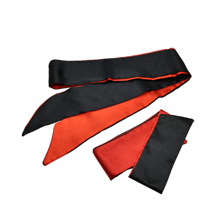 A reversible sash from the Sensual Scarlet Nights Beginner Bondage Collection for Curious Couples, with one black side and one red, shown on a white background—one end folded, the other laid flat.