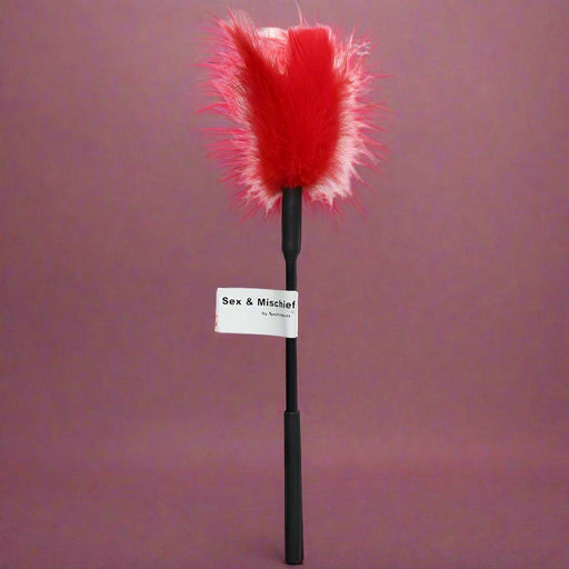 The Sex and Mischief 7" Feather Tickler by Sportsheets features a red feather with a black handle and a label that reads "Sex & Mischief".