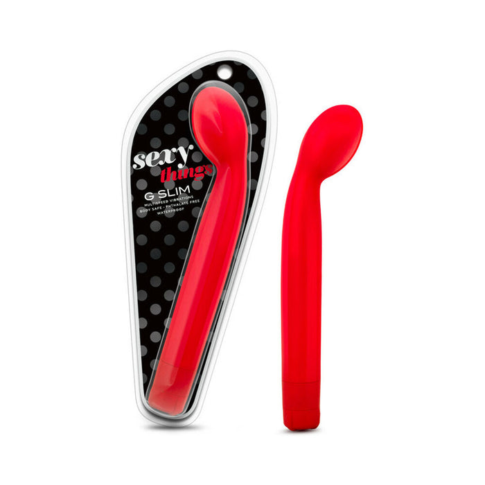 A red, curved Sexy Things Beginner Slim G-Spot Vibrator is shown next to its black and clear packaging with a gray polka dot background.