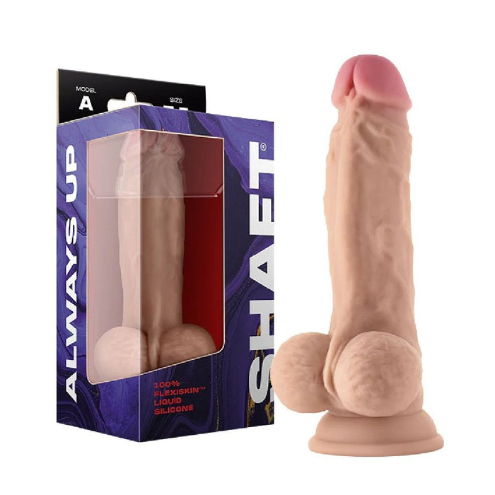 The Shaft Lifelike 7.5 Inch Light Tone Flexskin Silicone Dildo with Balls, made from Flexiskin liquid silicone for a realistic feel, is shown beside its blue and purple "SHAFT ALWAYS UP" branded packaging with a suction cup base.