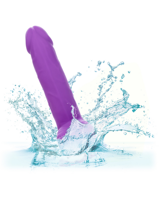 A CalExotics Silicone Stud 8 Inch Suction Cup Dildo - Purple splashes into the water.