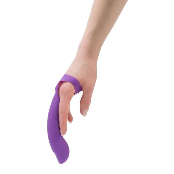 A manicured hand holds the Simple and True Silicone G-Spot Finger Extender in purple, looped around the index finger like an extension, showcased against a white background.