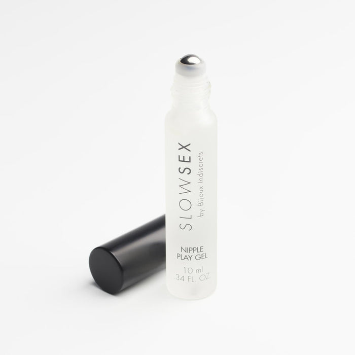 A clear frosted glass bottle of Slow Sex Nipple Play Gel with a roll-on applicator and black cap rests on a white background—ideal for exploring cooling sensations.