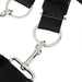 A close-up of a black strap with silver rings and clips, the durable and adjustable Sportsheets Under the Bed Restraint System is perfect for bondage setups, designed for secure fastening and easy attachment to additional gear or equipment.