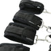 A close-up of the Sportsheets Under the Bed Restraint System showcases black soft restraints with adjustable straps and metal clips. The plush material ensures comfort and secure fastening, making it an ideal bondage bedroom addition. The brand name "Sportsheets" is visible on the straps.