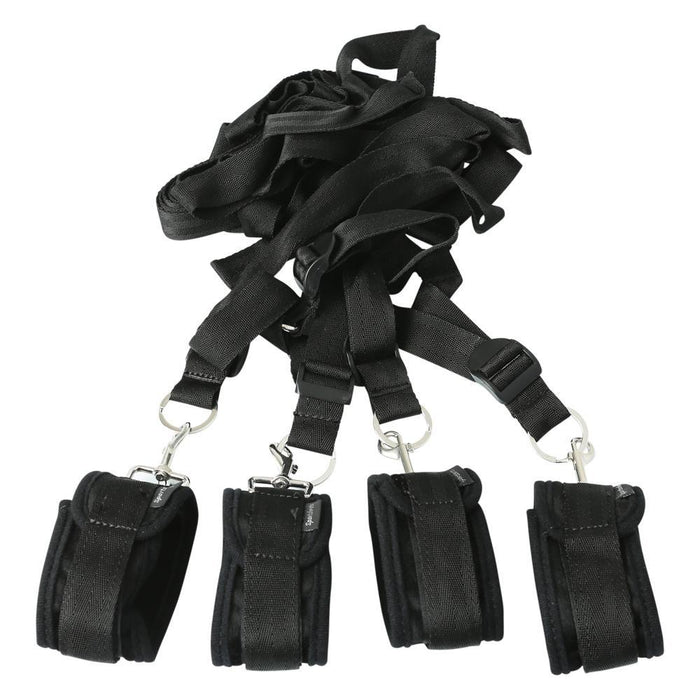 The Sportsheets Under the Bed Restraint System features four black adjustable restraints with padded cuffs and metal clasps on long nylon straps, creating a compact system. The paired cuffs enhance your bondage bedroom experience anywhere.