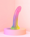 Stargazer Rainbow Ombre Glitter 7 inch Silicone Dildo on pink stand with pink background 