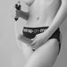 A woman holding the Strap-On-Me 7.5 Inch Silicone Squirting Dildo in Vanilla.