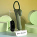 The Strap Tap & Go Girth Enhancer & Tapping Vibrator is shown on clear stands among pastel green cylinders. A white base labeled "Zero Tolerance" and a softly lit yellow-green background highlight this hands-free couples sex toy.