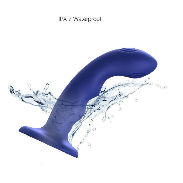 The Strap on Me Curved G-Spot Tapping Blue Silicone Dildo, with a flared base, is shown splashed with water to highlight its IPX7 waterproof feature.