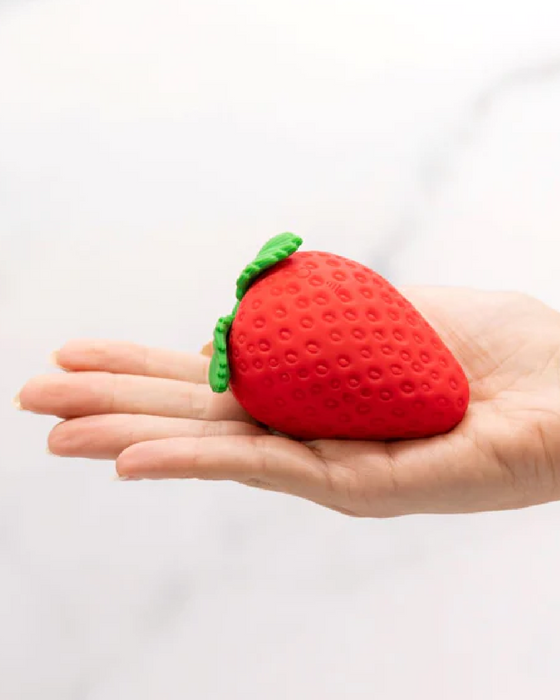 Strawberry Emojibator Clitoral Suction Vibrator laying in palm of hand 