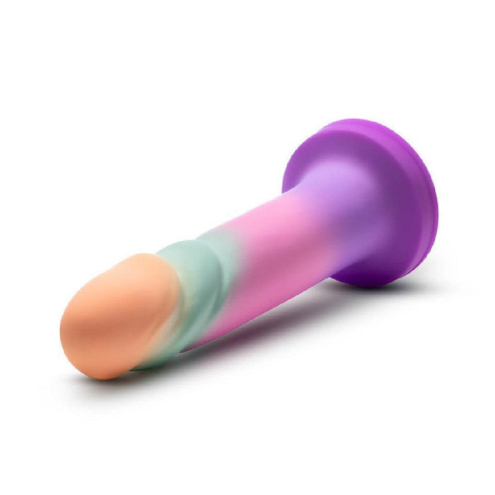 The Sunrise Gaze Textured Silicone Suction Cup 7.5 Inch Dildo, featuring a flesh-toned tip, light green shaft, and purple base, rests on a white background—ideal for G-spot stimulation and compatible with most strap-on harnesses.