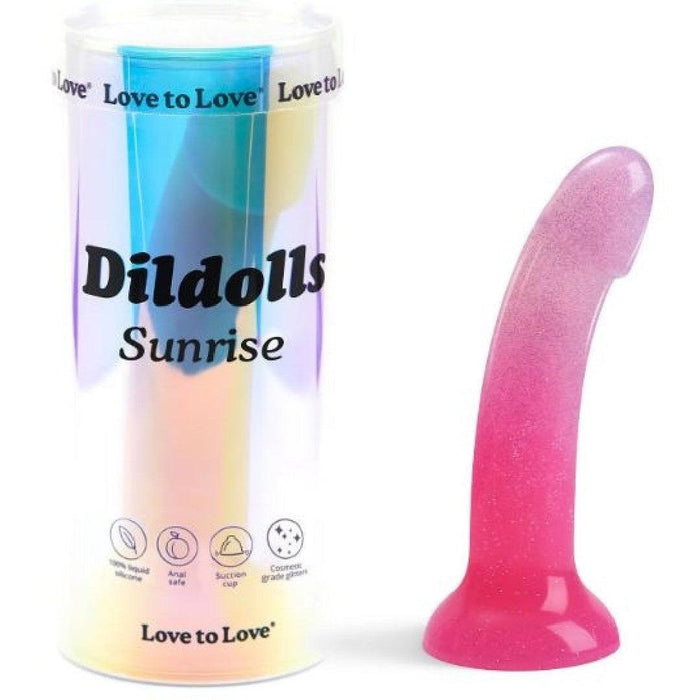 The Sunrise Smooth 7 Inch Pink Ombre Glitter Silicone Dildo with Suction Cup sits in colorful rainbow packaging, its flat base perfect for pegging, prostate, or g-spot play. Icons highlight this sparkling toy’s unique features.