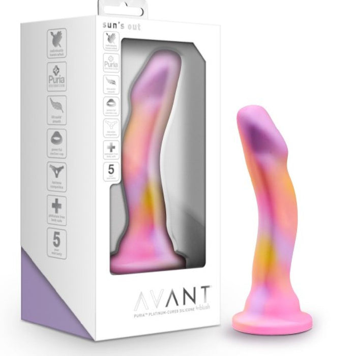 The Sun's Out 7.5 Inch Pink Ombre Silicone G Spot Dildo, featuring a curved, colorful design with a suction base and a pink-to-yellow gradient, is shown beside its "Avant" by Blush packaging, ideal for pegging.
