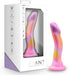 The Sun's Out 7.5 Inch Pink Ombre Silicone G Spot Dildo, featuring a curved, colorful design with a suction base and a pink-to-yellow gradient, is shown beside its "Avant" by Blush packaging, ideal for pegging.