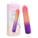 The Sunset Passion Soft Bendable Bullet Vibrator, in a pink, orange, and purple gradient, is shown beside its tropical-themed box featuring bold "play with me" branding and highlights like targeted vibrations.