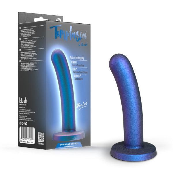 The Surrender Sleek Slim 5.75 Inch Blue Silicone Beginner & Pegging Dildo with a curved shape and flared base stands by its box, which features “Temptasia by blush” and product details in blue and white.