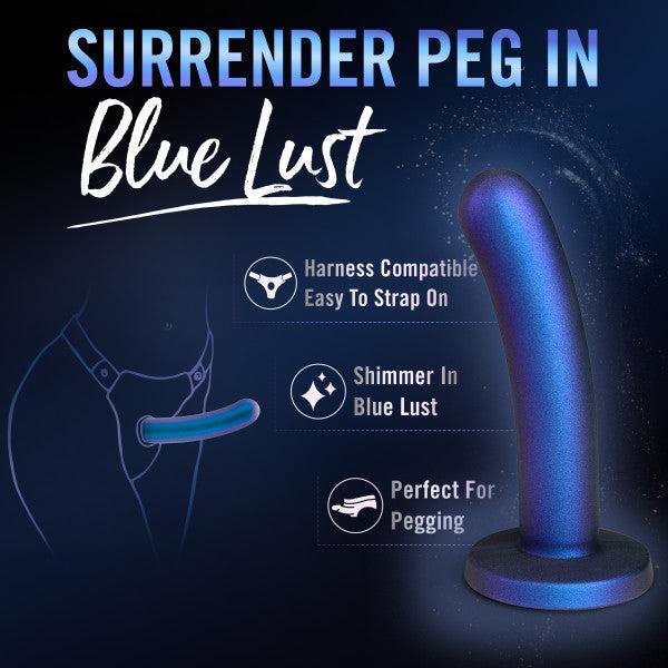 Promotional image for "Surrender Sleek Slim 5.75 Inch Blue Silicone Beginner & Pegging Dildo" featuring a shimmering blue, harness-compatible silicone dildo, perfect for pegging or anal play. Includes text callouts and a silhouette illustration.
