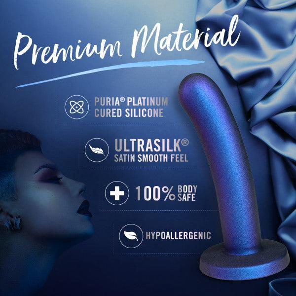 The Surrender Sleek Slim 5.75 Inch Blue Silicone Beginner & Pegging Dildo rests on silky blue fabric, featuring premium platinum-cured silicone, a satin-smooth feel, 100% body-safe, hypoallergenic—perfect for comfortable anal play.