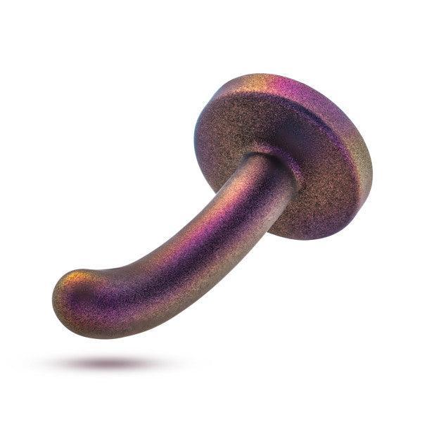 The Surrender Small 4.75 Inch Purple Silicone Beginner & Pegging Dildo features a metallic, iridescent finish with a rounded base and curved shaft, shifting between purple, gold, and bronze for vibrant dildo play. Displayed against a white background.