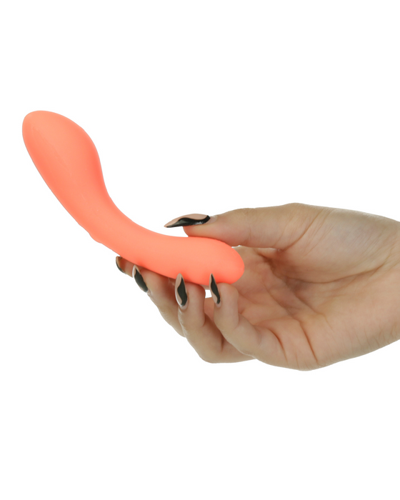 Mini Swan Glow in the Dark Double Ended Vibrator - Orange in model\s hand 