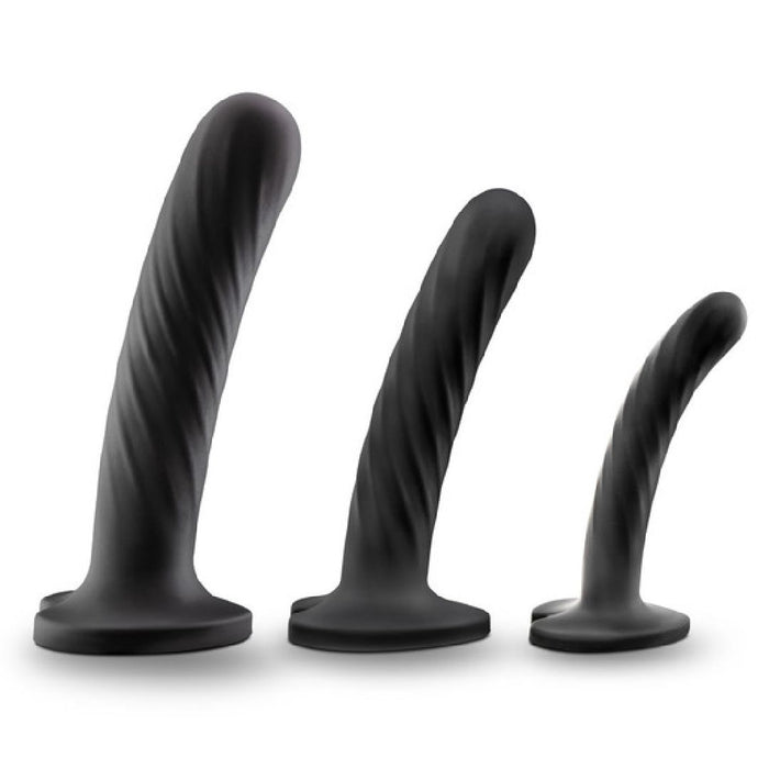 The Temptasia Twist Set of 3 Curved Black Silicone Pegging Dildos, spiral-textured and body-safe with flared bases, are lined up in ascending size from right to left for safe and satisfying G-spot stimulation.