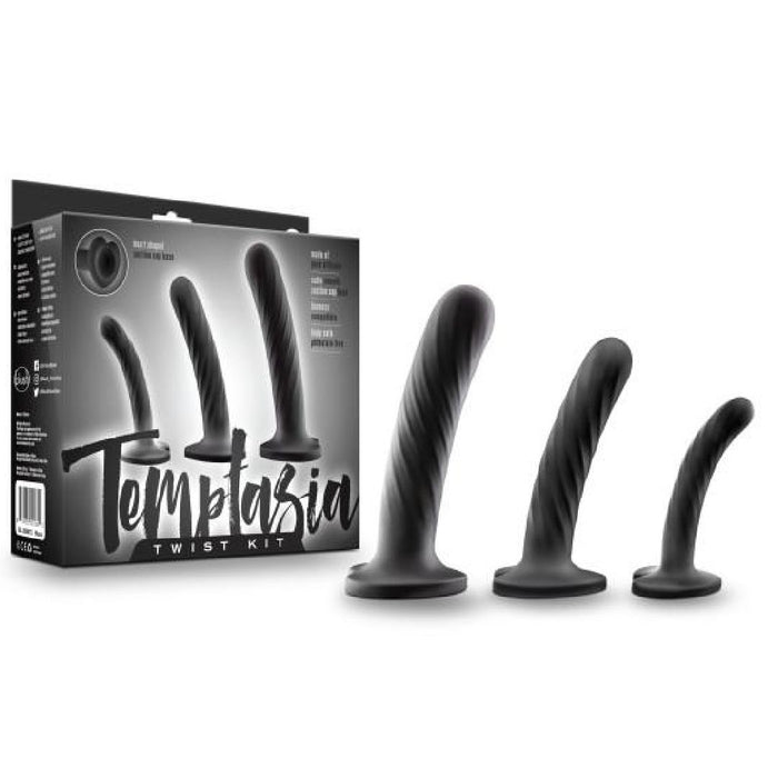The Temptasia Twist Set Of 3 Curved Black Silicone Pegging Dildos features three body-safe, spiral-textured dildos displayed beside packaging labeled "Temptasia Twist Kit" with images of the plugs.