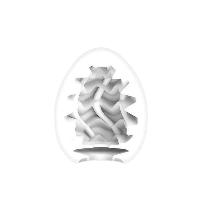 A white, egg-shaped Tenga Egg Disposable Penis Masturbator - Wavy is shown cut in half vertically, revealing its intricate, wavy textured interior pattern against a plain white background.
