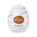 The Tenga Egg Disposable Penis Masturbator - Silky is an egg-shaped white toy with gold swirls and a brown label. Branded "TENGA" with "LIVE WITH WONDER," it’s a perfect disposable travel masturbation sleeve.