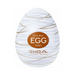 The Tenga Egg Disposable Penis Masturbator - Silky is an egg-shaped white toy with gold swirls and a brown label. Branded "TENGA" with "LIVE WITH WONDER," it’s a perfect disposable travel masturbation sleeve.