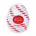 A white, egg-shaped Tenga Egg Standard 3 Pack Disposable Masturbators II stroker featuring red and gray diagonal patterns, with a central red circle displaying "EASY BEAT EGG TWISTER" and "TENGA LIVE WITH WONDER" in white text.