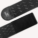 Close-up of The Handy TrueGrip Pro Band, a black elastic sleeve holder with wavy anti-slip silicone grip lines, Velcro ends, and a small “handy” logo on a leather-like patch.