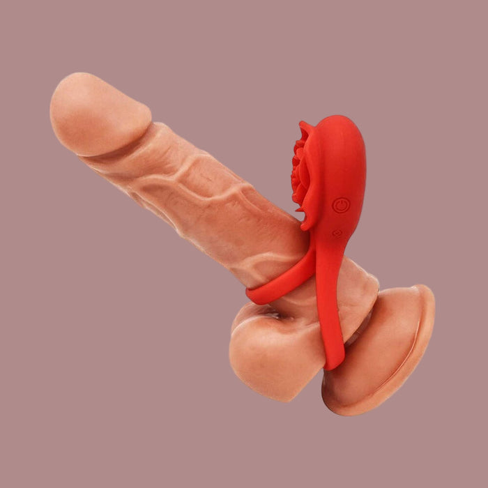 The Rose Vibrating Stretchy Remote Control Couples' Cock Ring is shown around a dildo's shaft and base for enhanced pleasure, set against a plain mauve background.