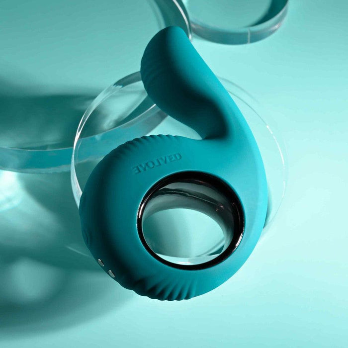 Teal silicone Thumbs Up vibrator with a thumb-shaped insertable tip, finger loop, and metallic trim.