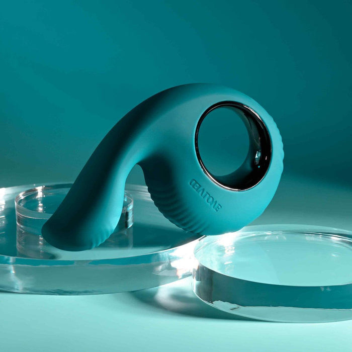 Teal silicone shallow penetration vibrator with a thumb-shaped insertable branch and a textured finger loop.