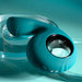 Teal silicone shallow penetration vibrator with a finger loop, textured insertable tip, and metallic control buttons.